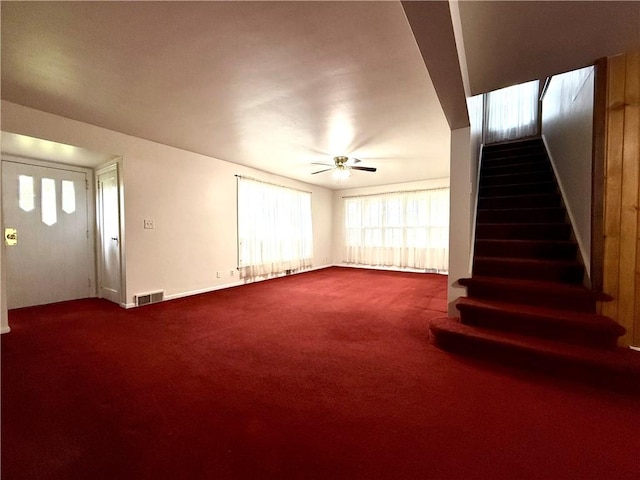 2225 Pleasantview Dr, Manor Twp, PA 16226 - unfurnished living room with stairs, dark carpet, plenty of natural light, and ceiling fan