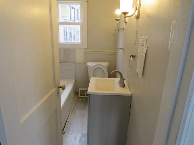 109 Parkfield St, Carrick, PA 15210 - full bath featuring a tub to relax in, vanity, wood finished floors, and toilet