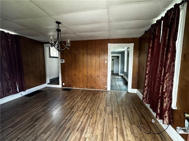 221 Friendship St, New Castle/5Th, PA 16101 - unfurnished dining area featuring wood finished floors, baseboards, a chandelier, wood walls, and a paneled ceiling