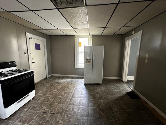 221 Friendship St, New Castle/5Th, PA 16101 - kitchen with white fridge with ice dispenser, gas stove, a paneled ceiling, and baseboards