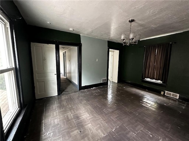 221 Friendship St, New Castle/5Th, PA 16101 - unfurnished room featuring a chandelier, baseboards, and a textured ceiling