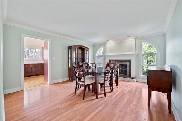 136 Wiegand Dr, Cranberry Twp, PA 16066 - dining room featuring ornamental molding, light wood-type flooring, and a glass covered fireplace