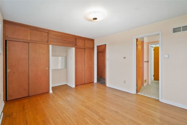 658 Bower Hill Rd, Peters Twp, PA 15367 - unfurnished bedroom featuring light wood-style floors, baseboards, and multiple closets