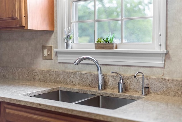 645 Dewalt Dr, Baldwin Twp, PA 15234 - kitchen with a sink, brown cabinetry, and light stone countertops