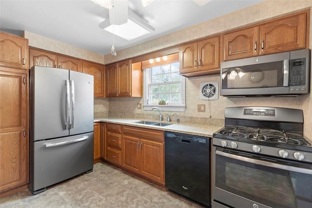 645 Dewalt Dr, Baldwin Twp, PA 15234 - kitchen featuring appliances with stainless steel finishes, a sink, light countertops, and brown cabinets