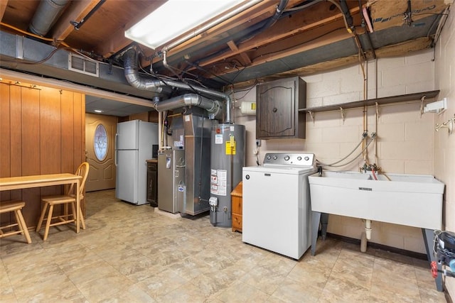 645 Dewalt Dr, Baldwin Twp, PA 15234 - unfinished below grade area with washer / dryer, freestanding refrigerator, water heater, heating unit, and concrete block wall