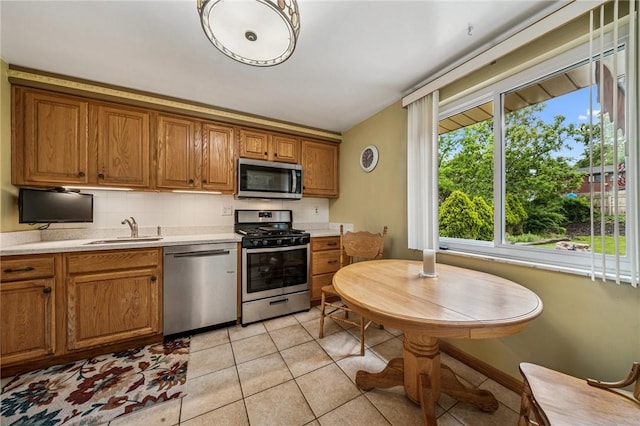 422 Mower Dr, Plum Boro, PA 15239 - kitchen with appliances with stainless steel finishes, a sink, brown cabinetry, and decorative backsplash