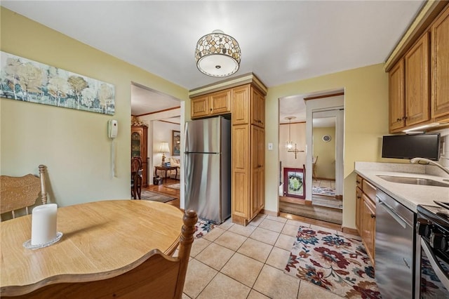 422 Mower Dr, Plum Boro, PA 15239 - kitchen featuring appliances with stainless steel finishes, a sink, light tile patterned floors, light countertops, and brown cabinetry