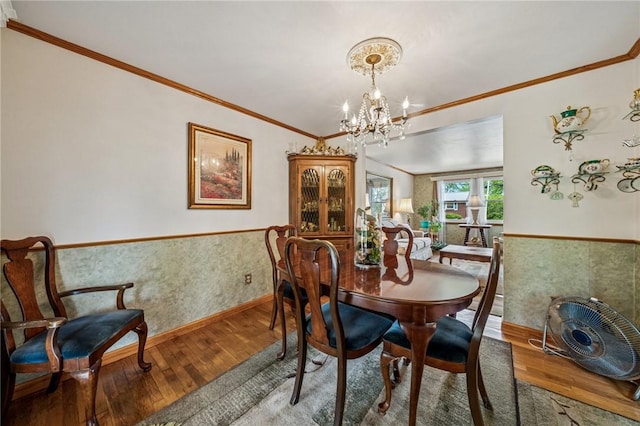 422 Mower Dr, Plum Boro, PA 15239 - dining space featuring ornamental molding, wood-type flooring, wainscoting, a chandelier, and baseboards