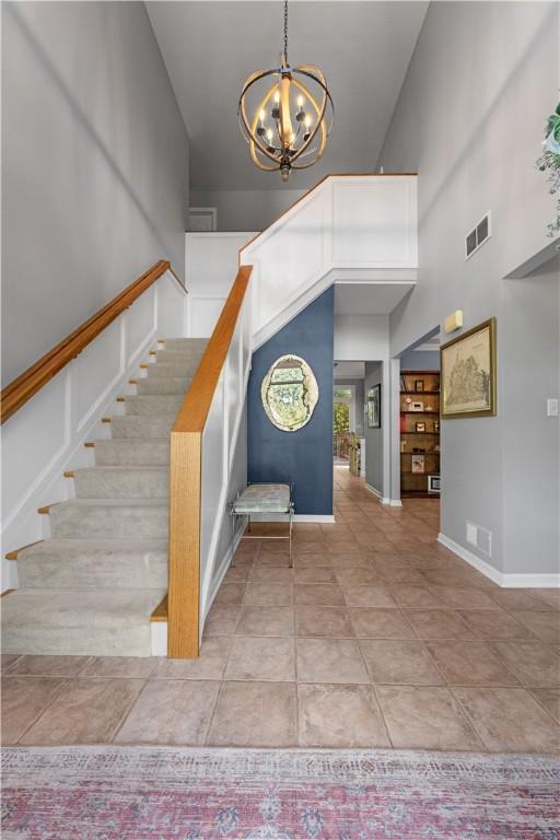 122 Hunter Dr, Cranberry Twp, PA 16066 - entrance foyer featuring stairway, a chandelier, a high ceiling, baseboards, and light tile patterned floors