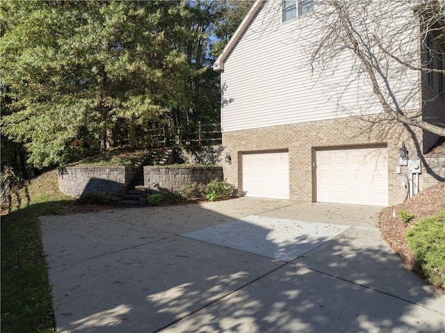 122 Hunter Dr, Cranberry Twp, PA 16066 - view of home's exterior featuring brick siding, a garage, and driveway