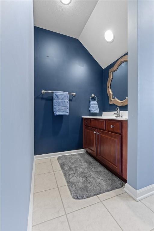 122 Hunter Dr, Cranberry Twp, PA 16066 - bathroom with vaulted ceiling, vanity, tile patterned flooring, and baseboards