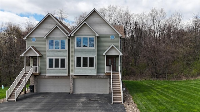 373 Cherokee Dr, Chippewa Twp, PA 15010 - view of front of home with stairs, a front lawn, asphalt driveway, and a garage