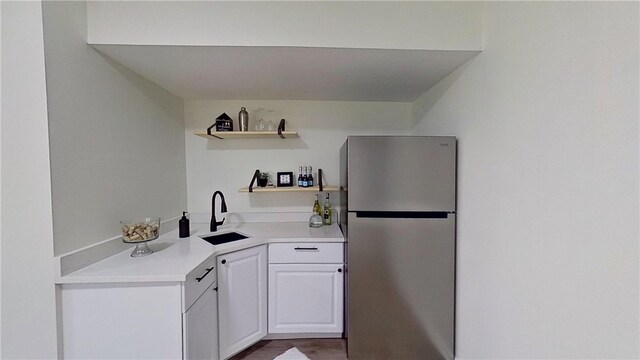 373 Cherokee Dr, Chippewa Twp, PA 15010 - kitchen featuring freestanding refrigerator, a sink, open shelves, white cabinets, and light countertops