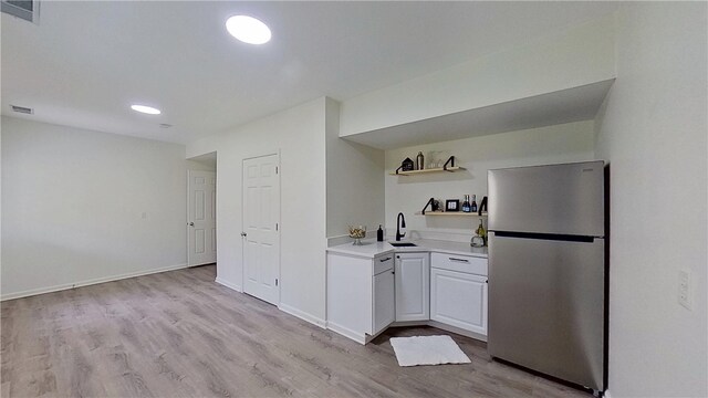 373 Cherokee Dr, Chippewa Twp, PA 15010 - kitchen featuring freestanding refrigerator, open shelves, light countertops, light wood-style flooring, and a sink