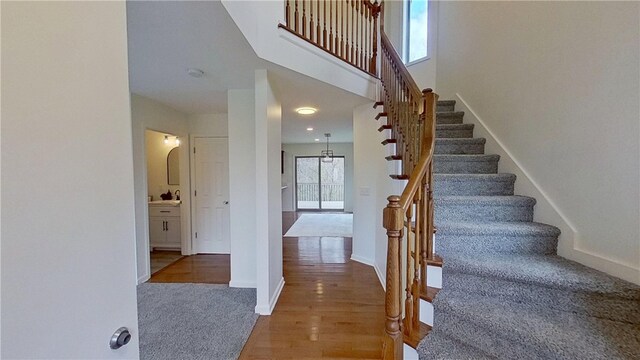 373 Cherokee Dr, Chippewa Twp, PA 15010 - staircase featuring baseboards, wood finished floors, and carpet floors