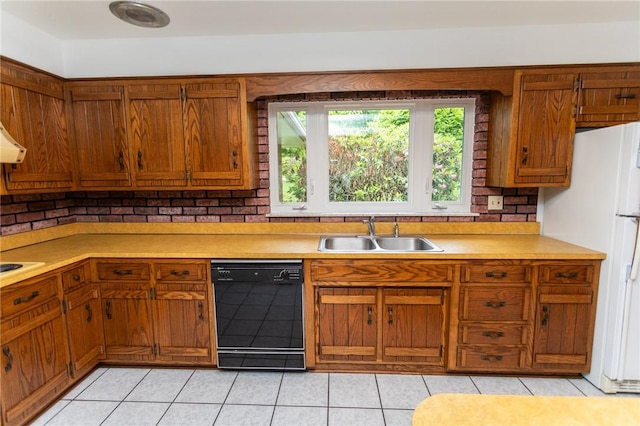 240 Connellsville St, Dunbar, PA 15431 - kitchen with dishwasher, a sink, freestanding refrigerator, brown cabinetry, and light countertops