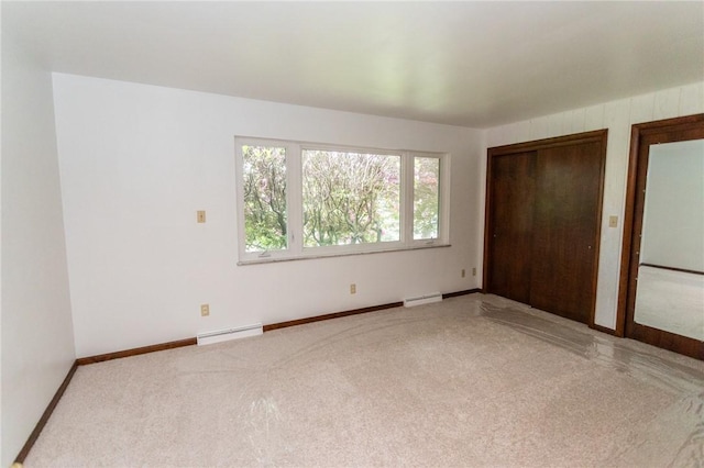 240 Connellsville St, Dunbar, PA 15431 - unfurnished bedroom featuring a baseboard heating unit, carpet floors, and baseboards
