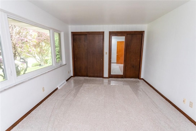 240 Connellsville St, Dunbar, PA 15431 - unfurnished bedroom with light colored carpet, baseboards, baseboard heating, and a closet