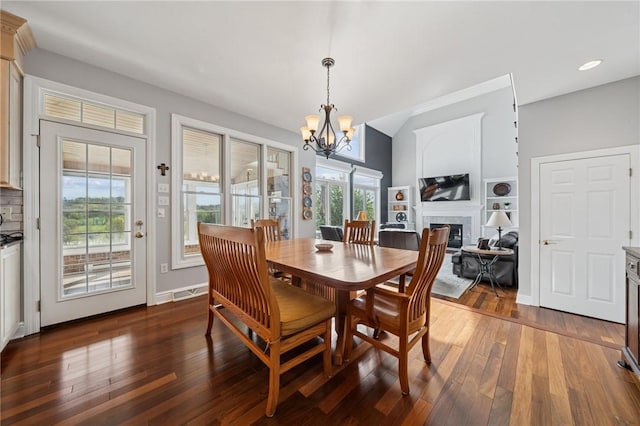 805 Saddleback Ct, Hempfield Twp Wml, PA 15601 - dining room featuring a chandelier, plenty of natural light, hardwood / wood-style floors, and a fireplace
