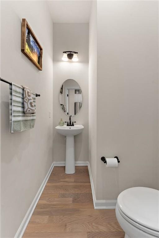 1001 Mohawk Ln, Marshall, PA 16046 - half bathroom featuring wood finished floors, toilet, baseboards, and a sink