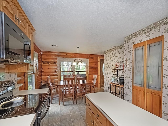 1646 Millers Run Rd, Mount Pleasant Twp Was, PA 15057 - kitchen with black appliances, log walls, a textured ceiling, wallpapered walls, and a chandelier