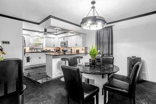 1228 Soles St, Mckeesport, PA 15132 - dining area with crown molding, a chandelier, and ceiling fan