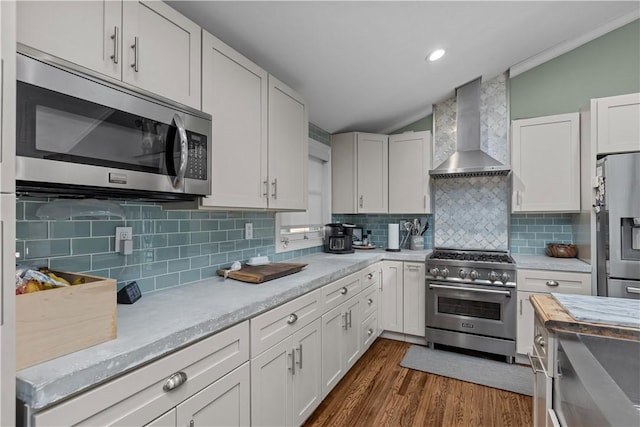 22 Green Crescent Dr, South Strabane, PA 15301 - kitchen with stainless steel appliances, wall chimney exhaust hood, lofted ceiling, light countertops, and dark wood-style flooring