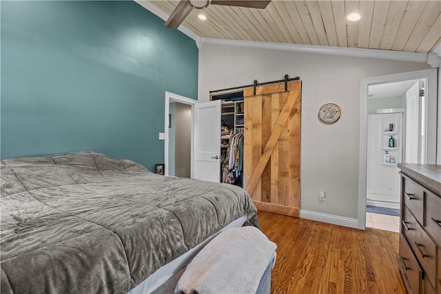 22 Green Crescent Dr, South Strabane, PA 15301 - bedroom with vaulted ceiling, a barn door, baseboards, ornamental molding, and a spacious closet