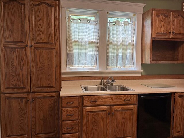 216 Center St, Slippery Rock Boro, PA 16057 - kitchen with dishwasher, a sink, brown cabinetry, and light countertops