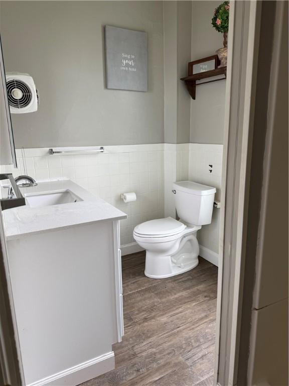216 Center St, Slippery Rock Boro, PA 16057 - half bath featuring tile walls, toilet, vanity, wood finished floors, and wainscoting
