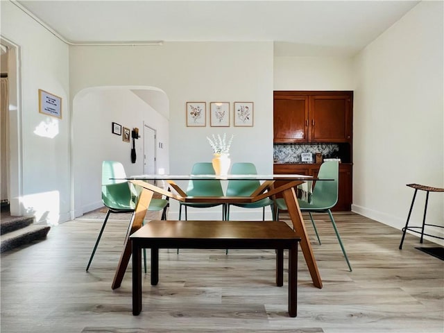 657 Grove St, City Of Greensburg, PA 15601 - dining room with arched walkways, light wood finished floors, and baseboards