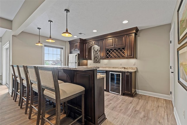 317 Buckingham Dr, Peters Twp, PA 15367 - indoor wet bar with beverage cooler, light wood-type flooring, baseboards, stainless steel refrigerator, and recessed lighting
