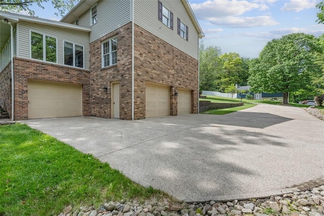 240 La Ray Dr, Center Twp But, PA 16001 - view of side of home with a garage, driveway, and brick siding