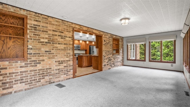 240 La Ray Dr, Center Twp But, PA 16001 - unfurnished living room featuring brick wall and light colored carpet