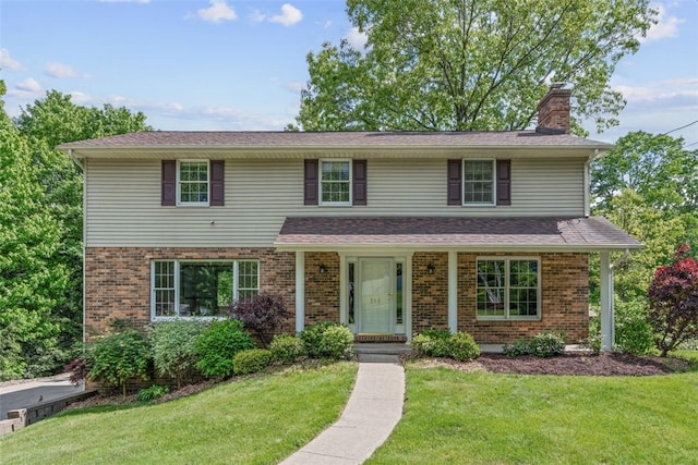 240 La Ray Dr, Center Twp But, PA 16001 - traditional home featuring a chimney, a front yard, and brick siding