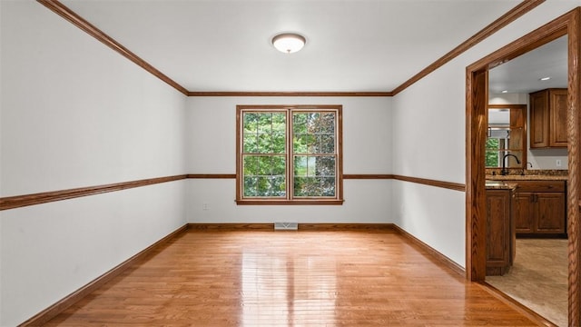 240 La Ray Dr, Center Twp But, PA 16001 - unfurnished room featuring light wood-style floors, baseboards, crown molding, and a sink
