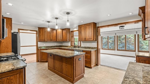 240 La Ray Dr, Center Twp But, PA 16001 - kitchen with freestanding refrigerator, a sink, brown cabinets, dark stone counters, and recessed lighting