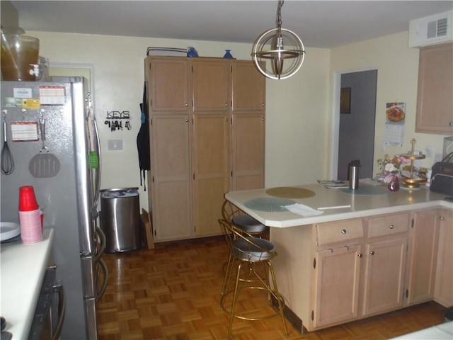 1260 Fox Chapel Rd, Fox Chapel, PA 15238 - kitchen with freestanding refrigerator, a peninsula, light countertops, and pendant lighting