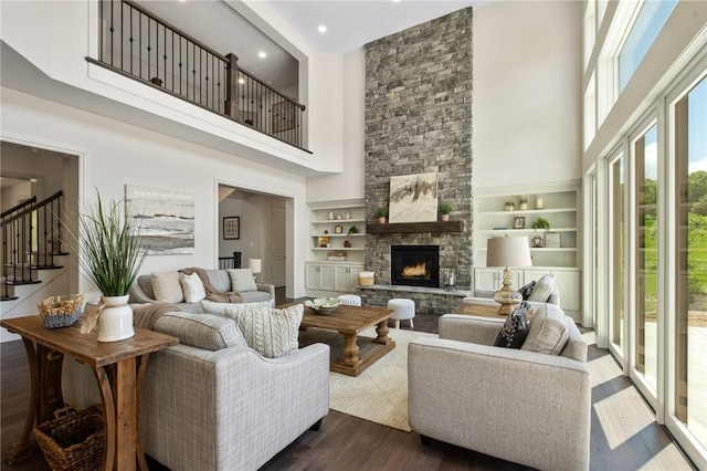 304 Azalea Ln, Marshall, PA 15005 - living area featuring a towering ceiling, built in shelves, dark wood-style flooring, a stone fireplace, and stairway