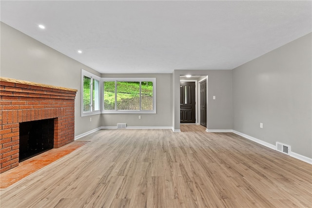 100 Old Legionville Rd, Economy, PA 15005 - unfurnished living room featuring baseboards, wood finished floors, a brick fireplace, and recessed lighting