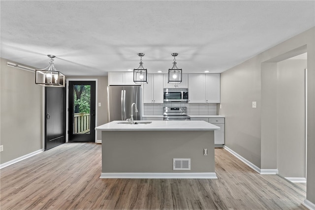 100 Old Legionville Rd, Economy, PA 15005 - kitchen with appliances with stainless steel finishes, a sink, light wood-style floors, decorative backsplash, and light countertops