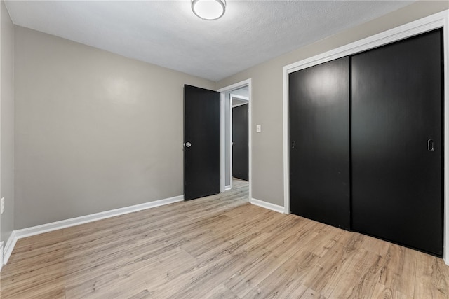 100 Old Legionville Rd, Economy, PA 15005 - unfurnished bedroom featuring light wood finished floors, a closet, and baseboards