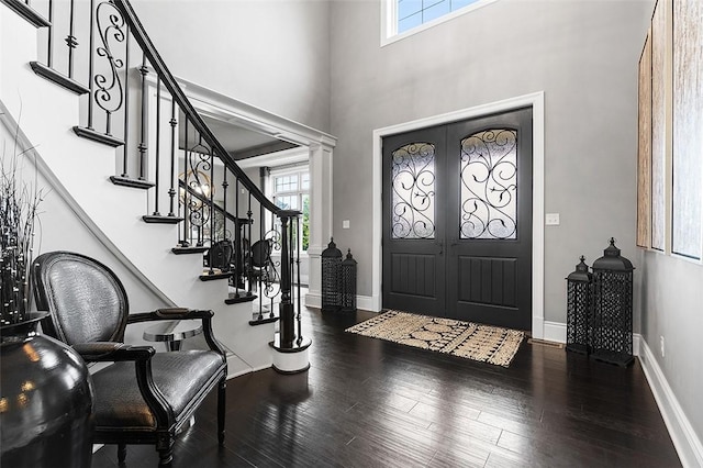 197 Wellington Cir, Peters Twp, PA 15317 - foyer featuring plenty of natural light, stairway, wood finished floors, a towering ceiling, and baseboards