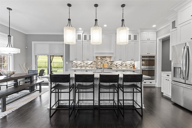 197 Wellington Cir, Peters Twp, PA 15317 - kitchen featuring appliances with stainless steel finishes, healthy amount of natural light, light countertops, crown molding, and recessed lighting