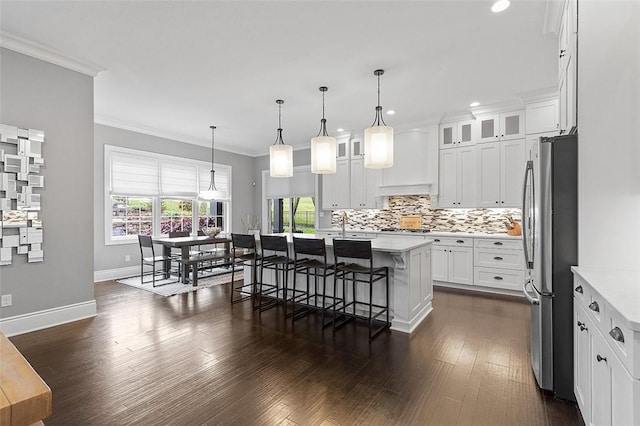 197 Wellington Cir, Peters Twp, PA 15317 - kitchen featuring freestanding refrigerator, light countertops, backsplash, crown molding, and recessed lighting