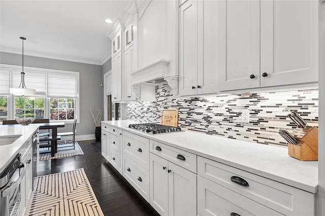 197 Wellington Cir, Peters Twp, PA 15317 - kitchen with stainless steel gas stovetop, ornamental molding, baseboards, light countertops, and white cabinets