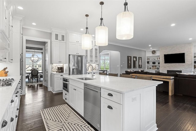 197 Wellington Cir, Peters Twp, PA 15317 - kitchen featuring stainless steel appliances, a sink, crown molding, glass insert cabinets, and recessed lighting