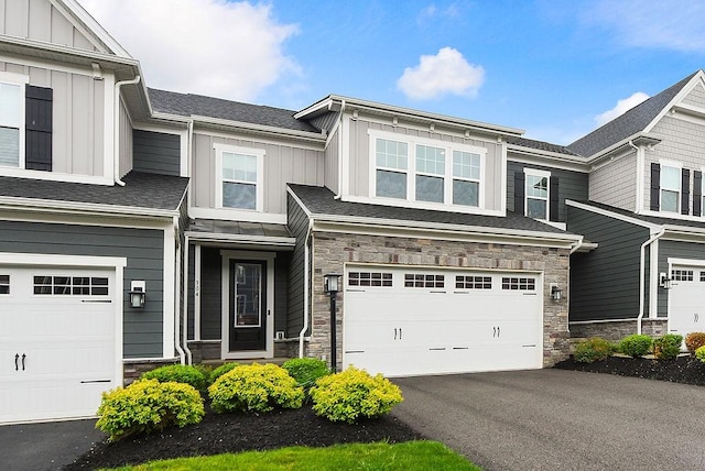 304 Spruce Ln, North Strabane, PA 15317 - view of front of house featuring board and batten siding, stone siding, and a garage