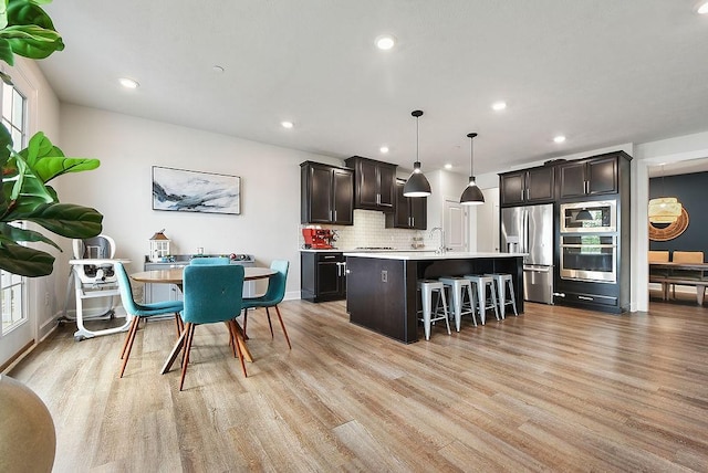 304 Spruce Ln, North Strabane, PA 15317 - kitchen featuring stainless steel appliances, light countertops, a kitchen bar, healthy amount of natural light, and recessed lighting